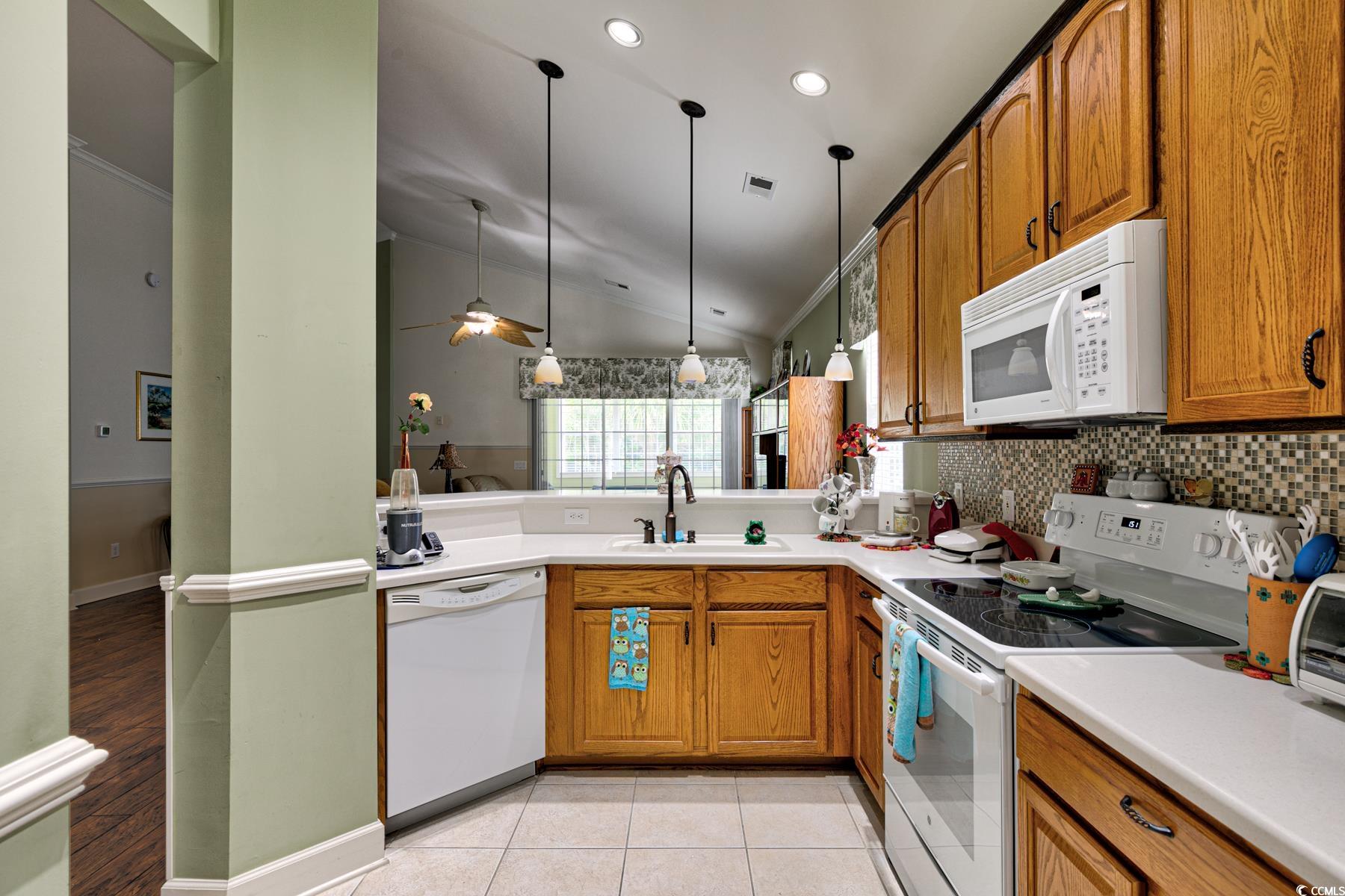 854 Laquinta Loop Murrells Inlet, SC 29576 - Photo 7 of 38 Kitchen with white appliances, sink, lofted ceilin