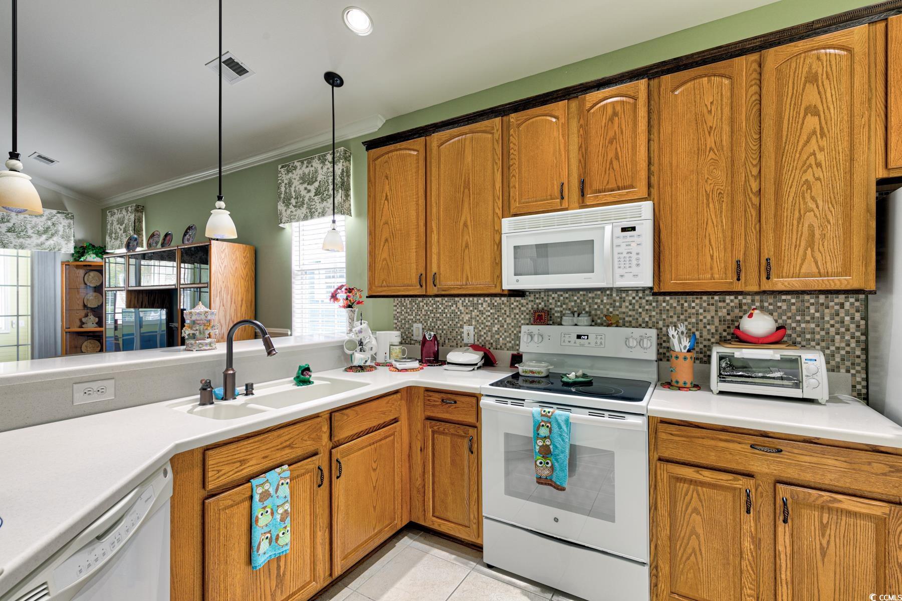 854 Laquinta Loop Murrells Inlet, SC 29576 - Photo 8 of 38 Kitchen featuring crown molding, white appliances,