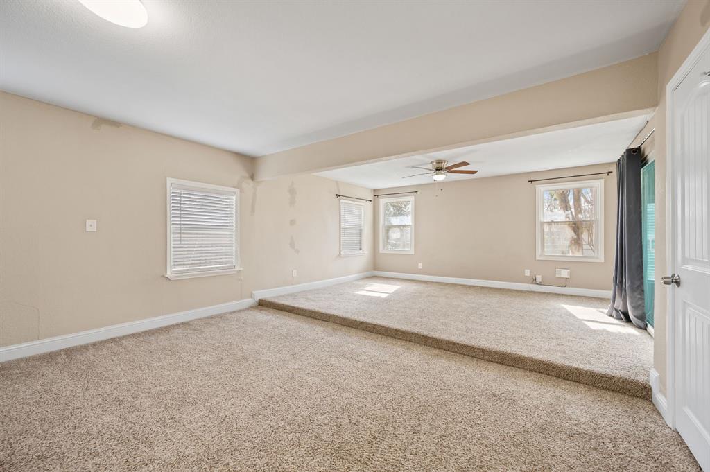 904 Treasure Road Garland, TX 75041 - Photo 16 of 27 an empty room with windows and closet
