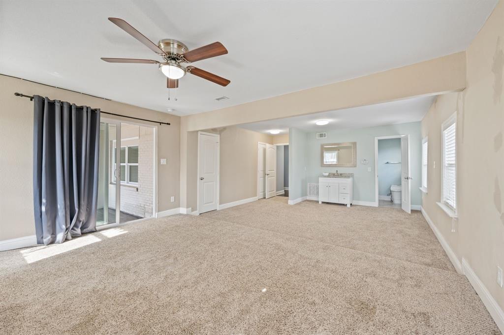 904 Treasure Road Garland, TX 75041 - Photo 17 of 27 a view of an empty room with a ceiling fan