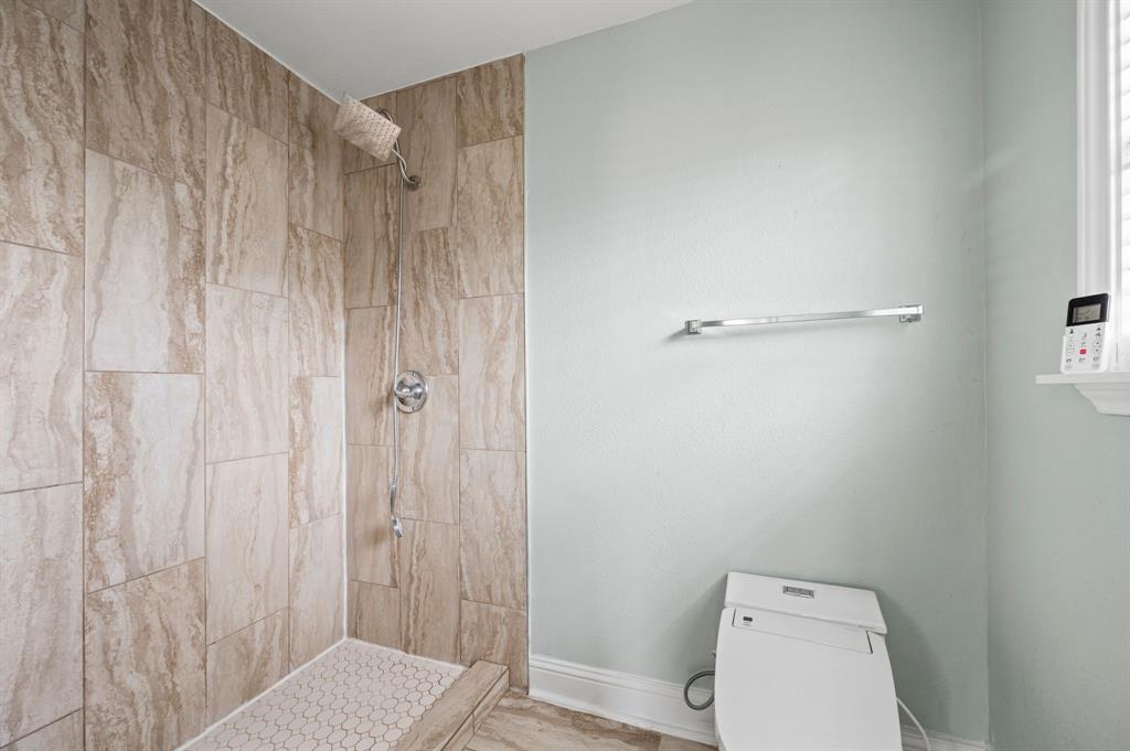 904 Treasure Road Garland, TX 75041 - Photo 20 of 27 a bathroom with a toilet and a shower curtain