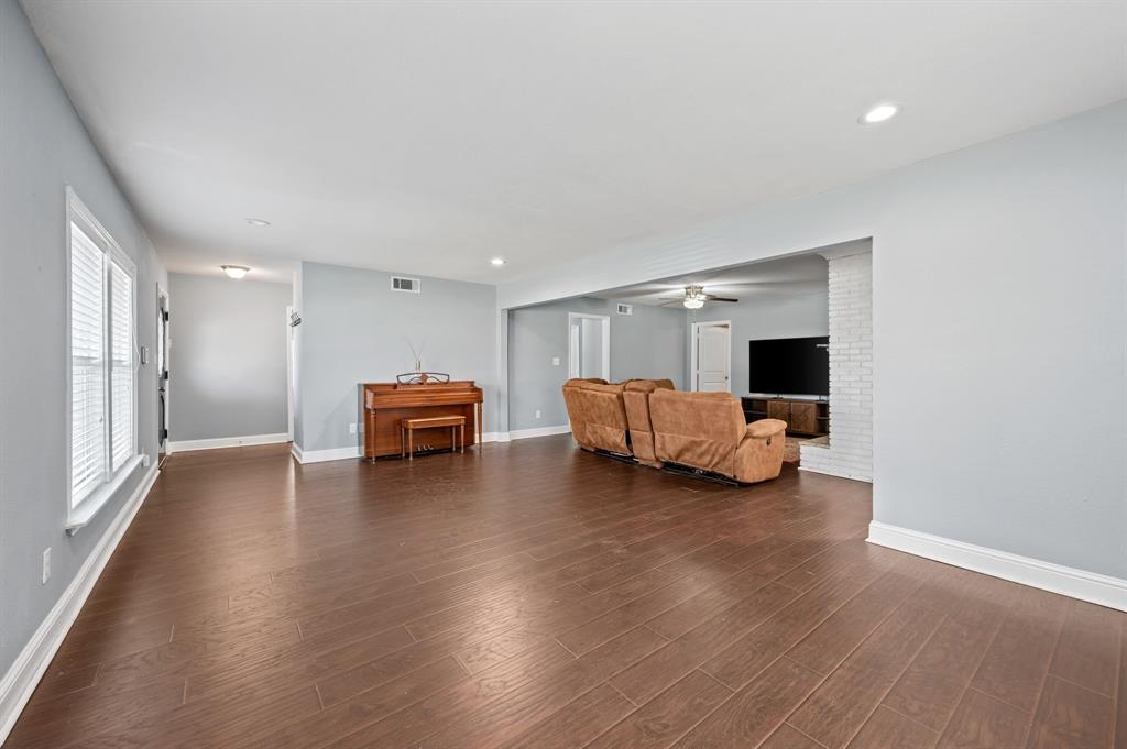 904 Treasure Road Garland, TX 75041 - Photo 6 of 27 a living room with furniture and a wooden floor