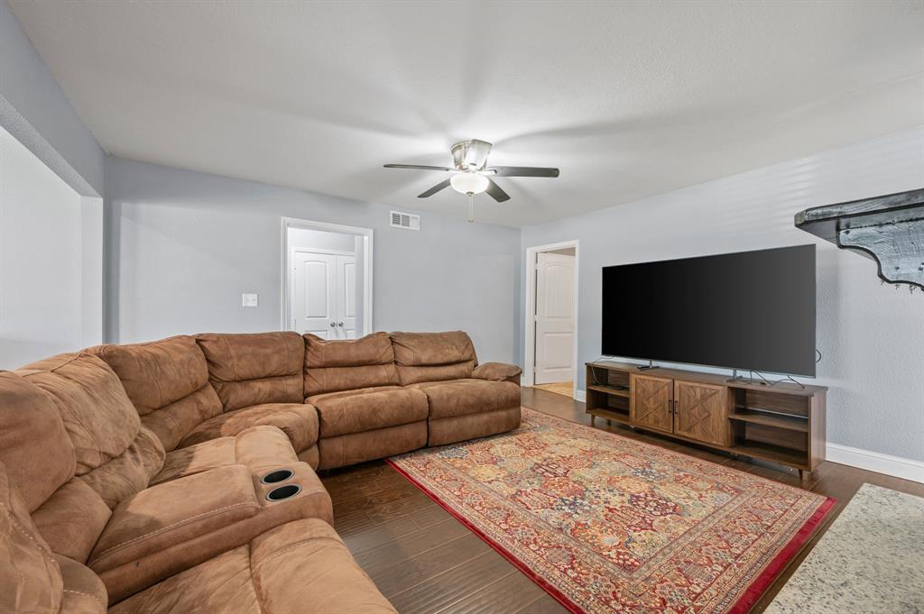 904 Treasure Road Garland, TX 75041 - Photo 7 of 27 a living room with furniture and a flat screen tv