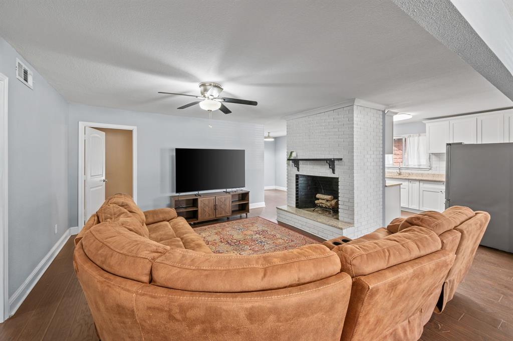 904 Treasure Road Garland, TX 75041 - Photo 8 of 27 a bedroom with a bed and a flat screen tv