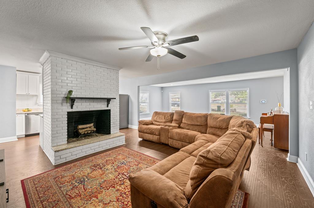 904 Treasure Road Garland, TX 75041 - Photo 9 of 27 a living room with furniture and a fireplace