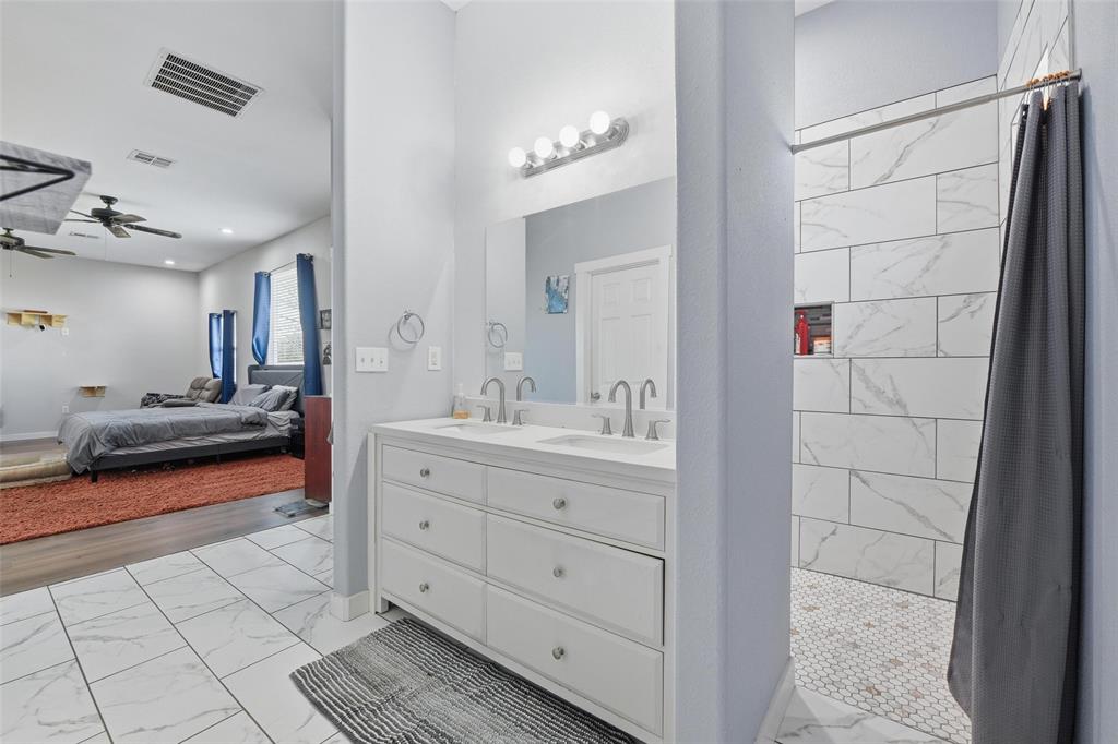379 Private Road, Unit 4650 Boyd, TX 76023 - Photo 15 of 40 Ensuite bathroom featuring light marble finish flooring, a stall shower, double vanity, and ceiling fan