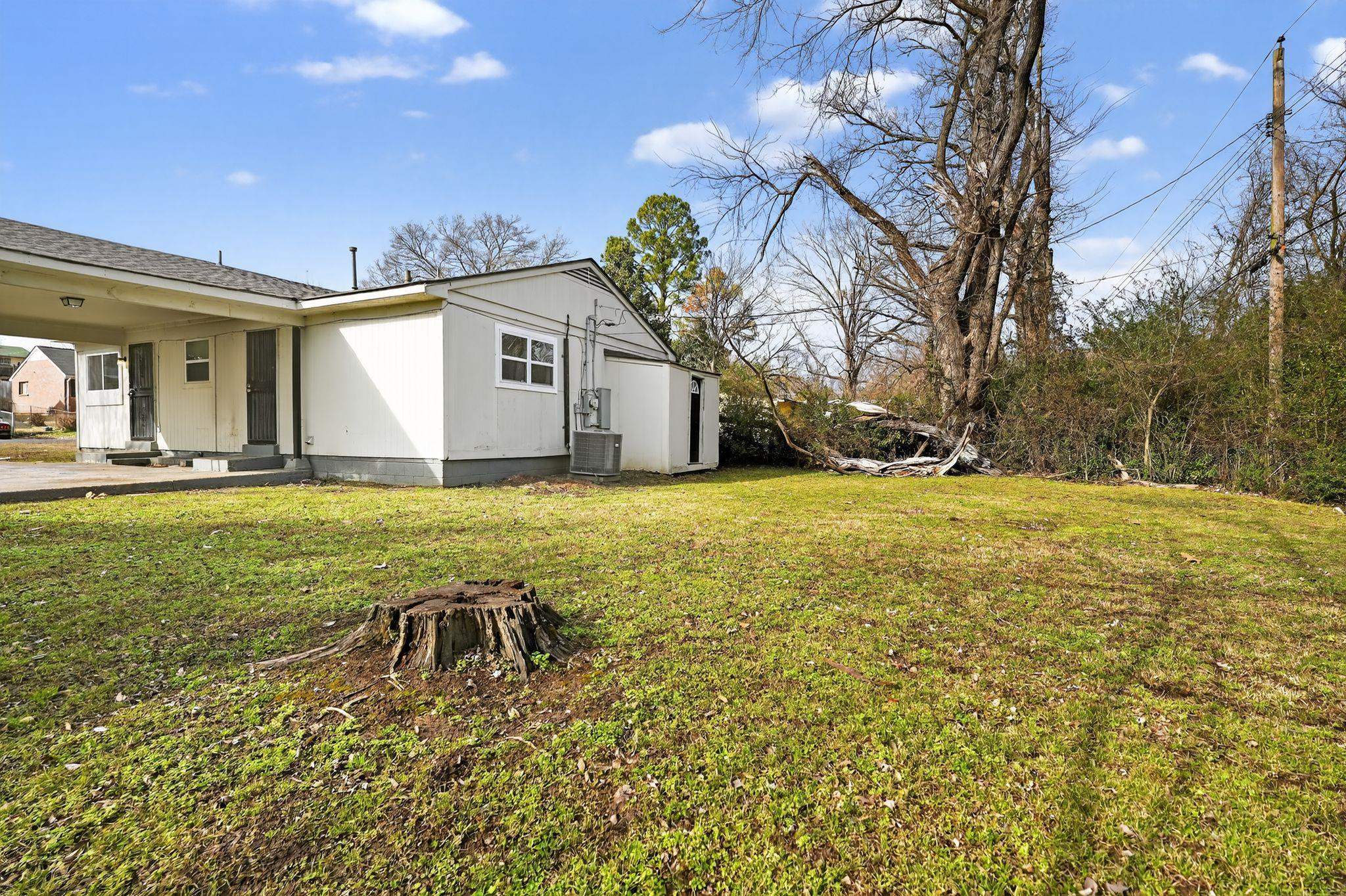 4212 Falcon Drive Memphis, TN 38109 - Photo 16 of 31 View of grassy yard with an attached carport and a patio