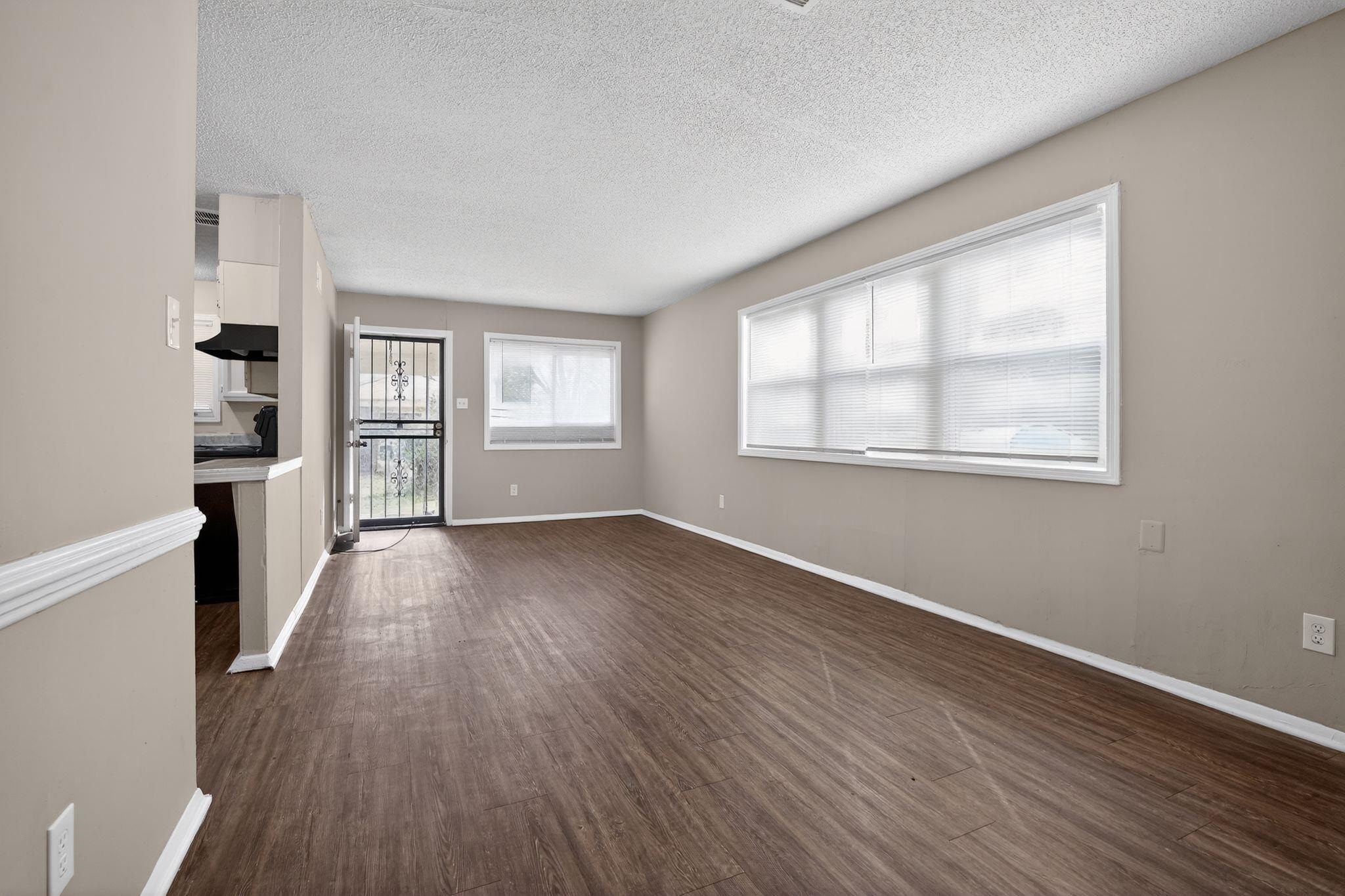 4212 Falcon Drive Memphis, TN 38109 - Photo 22 of 31 Unfurnished living room featuring dark wood finished floors and a textured ceiling