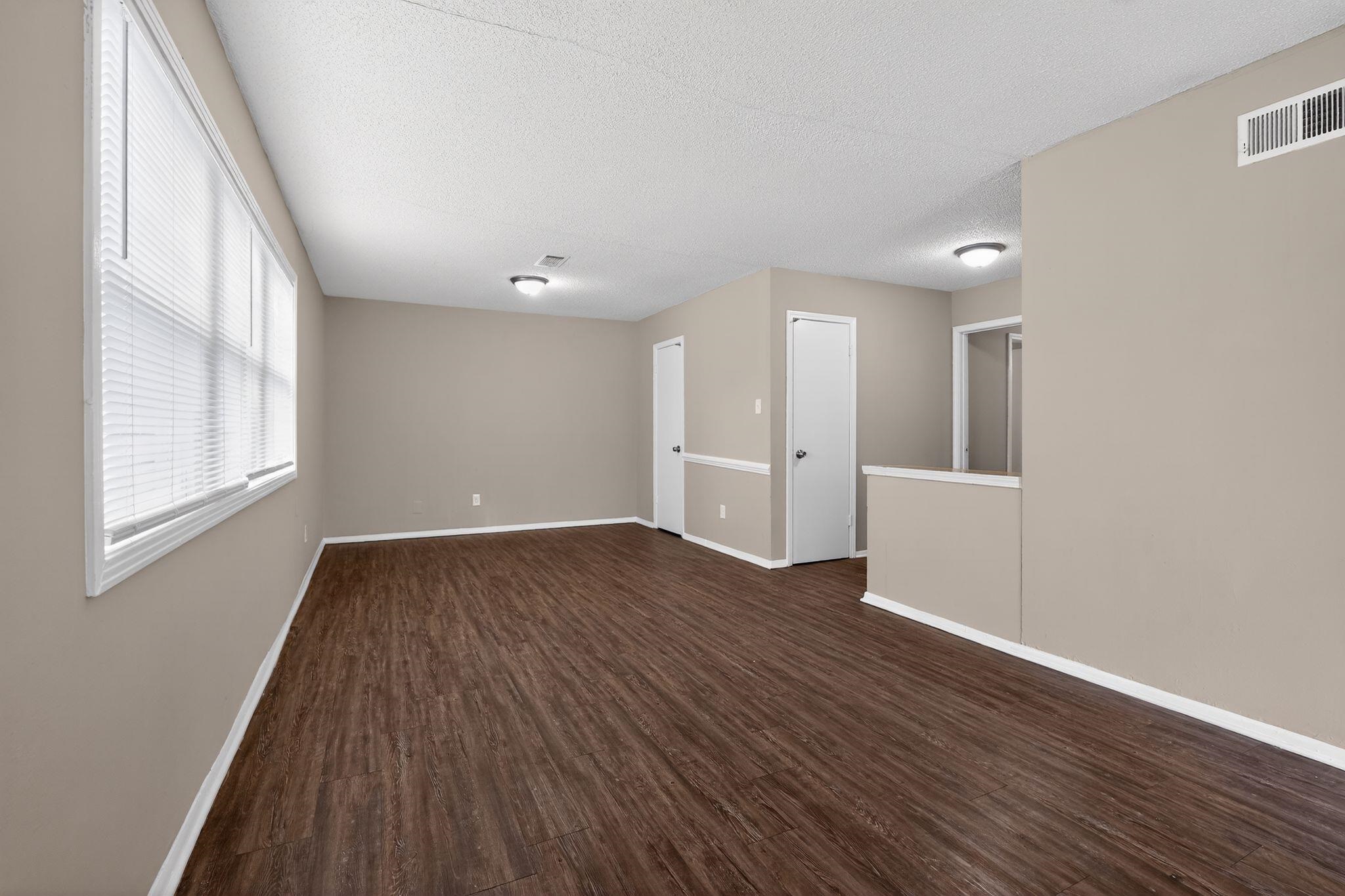 4212 Falcon Drive Memphis, TN 38109 - Photo 24 of 31 Spare room with dark wood finished floors and a textured ceiling