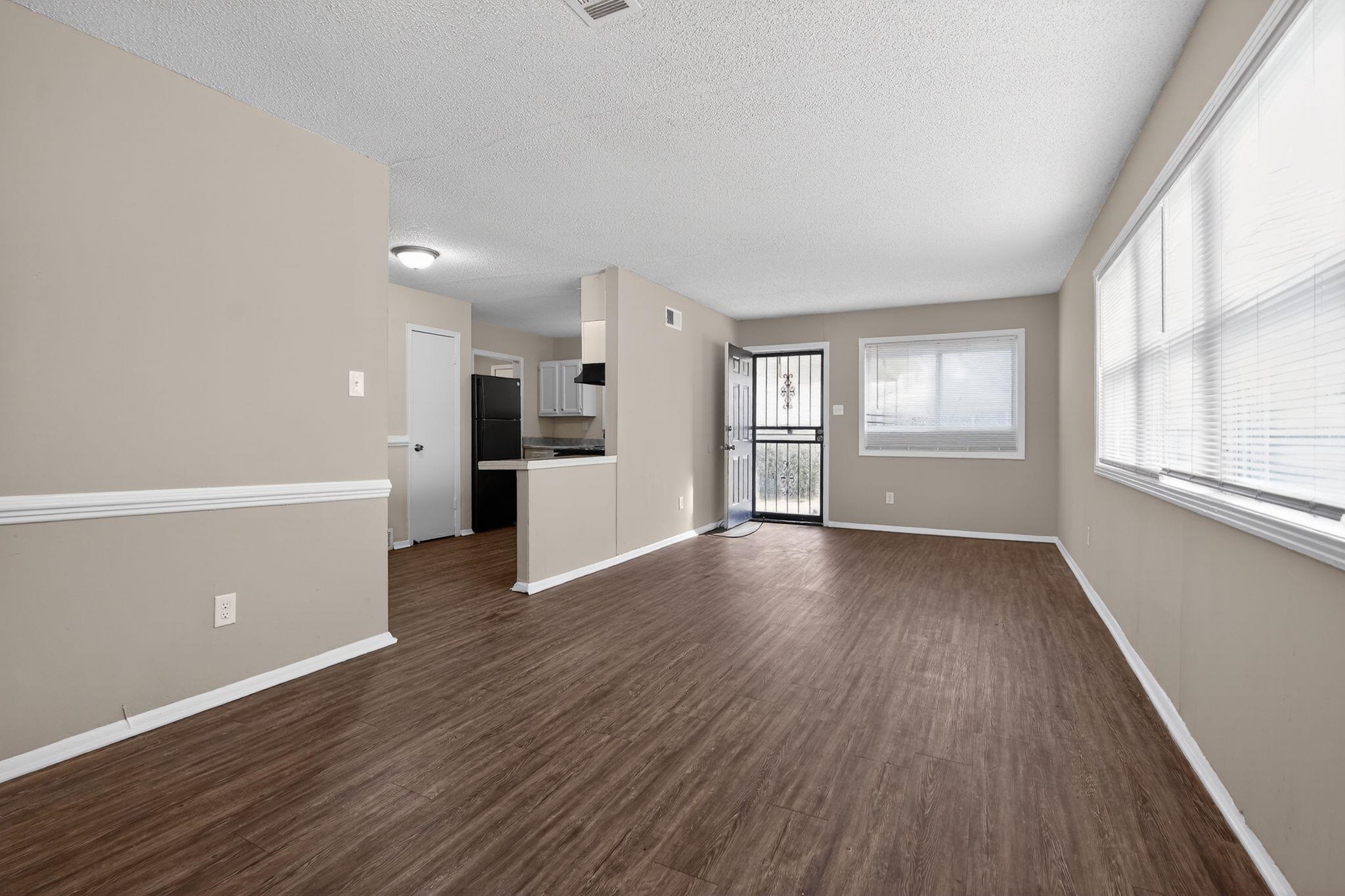 4212 Falcon Drive Memphis, TN 38109 - Photo 25 of 31 Unfurnished living room featuring dark wood-type flooring and a textured ceiling