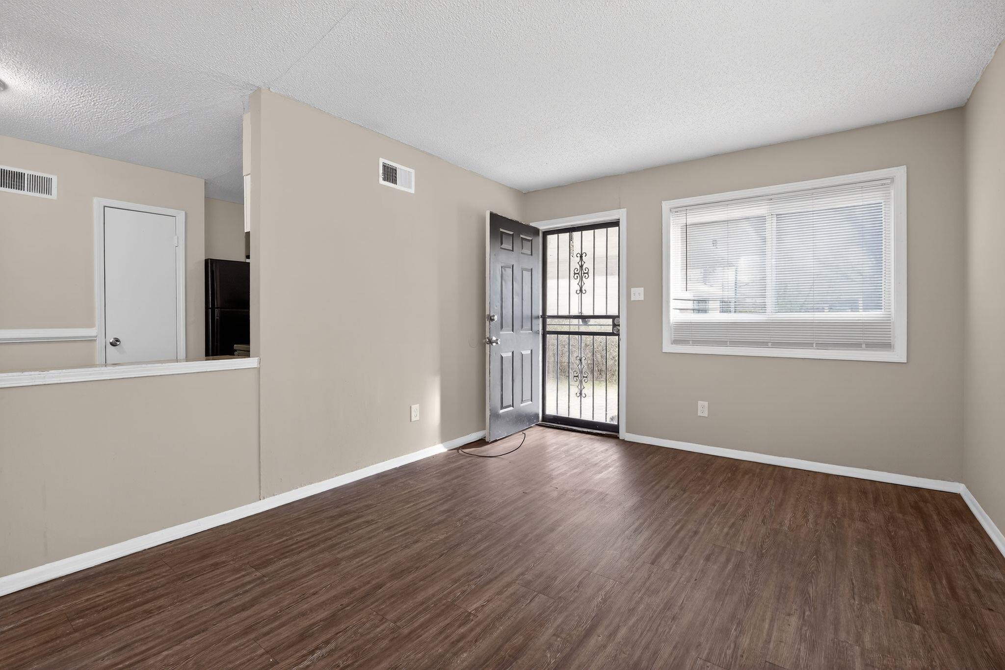 4212 Falcon Drive Memphis, TN 38109 - Photo 26 of 31 Empty room with dark wood finished floors and a textured ceiling