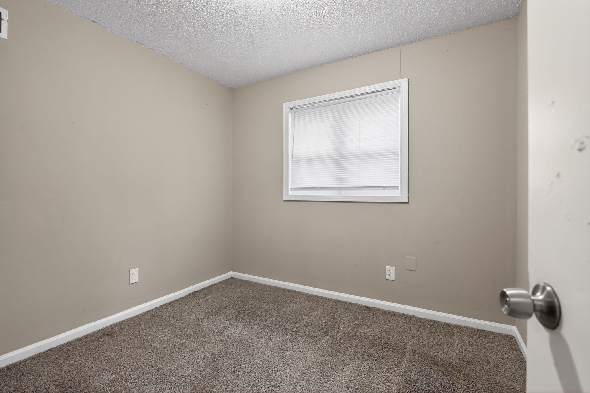 4212 Falcon Drive Memphis, TN 38109 - Photo 30 of 31 Unfurnished room featuring a textured ceiling and carpet flooring