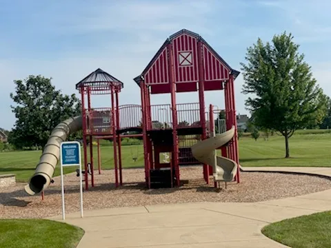 a view of a house with a yard and slide