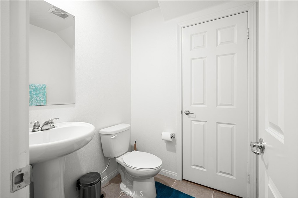 8652 Cava Drive Rancho Cucamonga, CA 91730 - Photo 12 of 28 a bathroom with a toilet sink and mirror