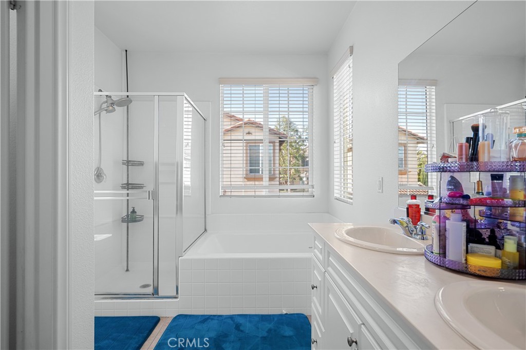 8652 Cava Drive Rancho Cucamonga, CA 91730 - Photo 19 of 28 a bathroom with a tub sink vanity and mirror