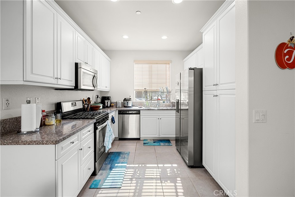 8652 Cava Drive Rancho Cucamonga, CA 91730 - Photo 10 of 28 a kitchen with stainless steel appliances granite countertop a stove a sink and a refrigerator