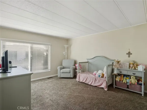 a bedroom with bed and a window