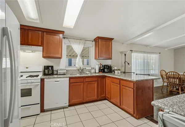 a kitchen with stainless steel appliances granite countertop a stove sink and cabinets