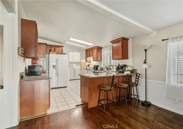 a kitchen with stainless steel appliances a refrigerator and a stove top oven