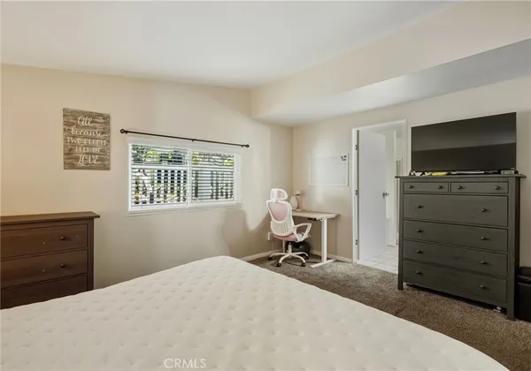 a bedroom with a bed and a television