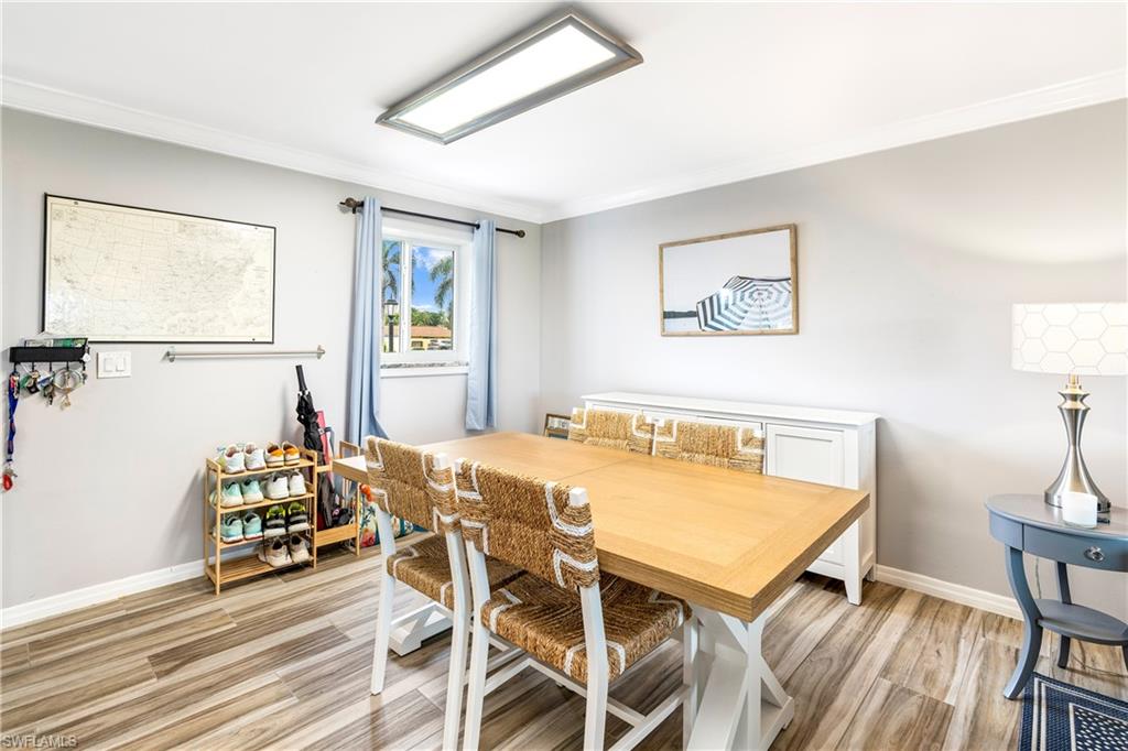 Dining room with crown molding and luxury vinyl floors