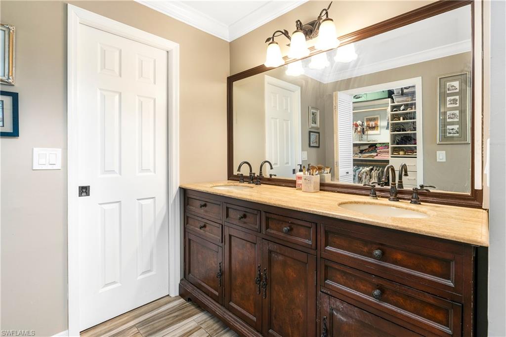 138 Teryl Road, Unit 43 Naples, FL 34112 - Photo 9 of 28 Ensuite Bathroom featuring ornamental molding, and vanity