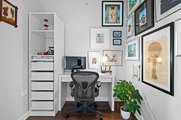 a view of a workspace with furniture and a window