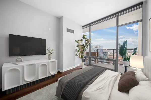 a bedroom with a bed and a flat screen tv
