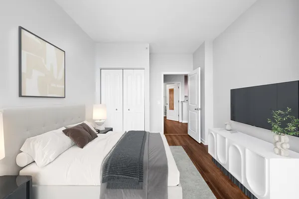 a bedroom with a bed and a flat screen tv