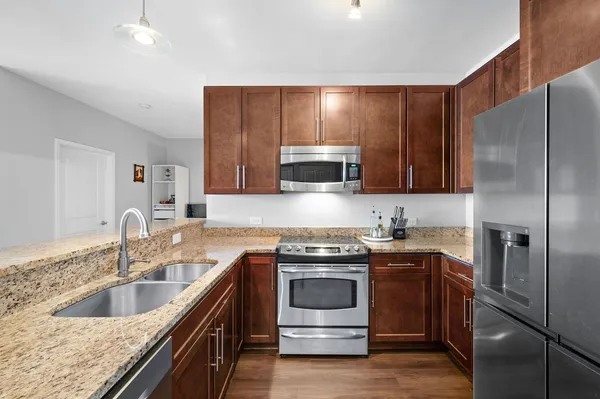 a kitchen with a sink stove and refrigerator
