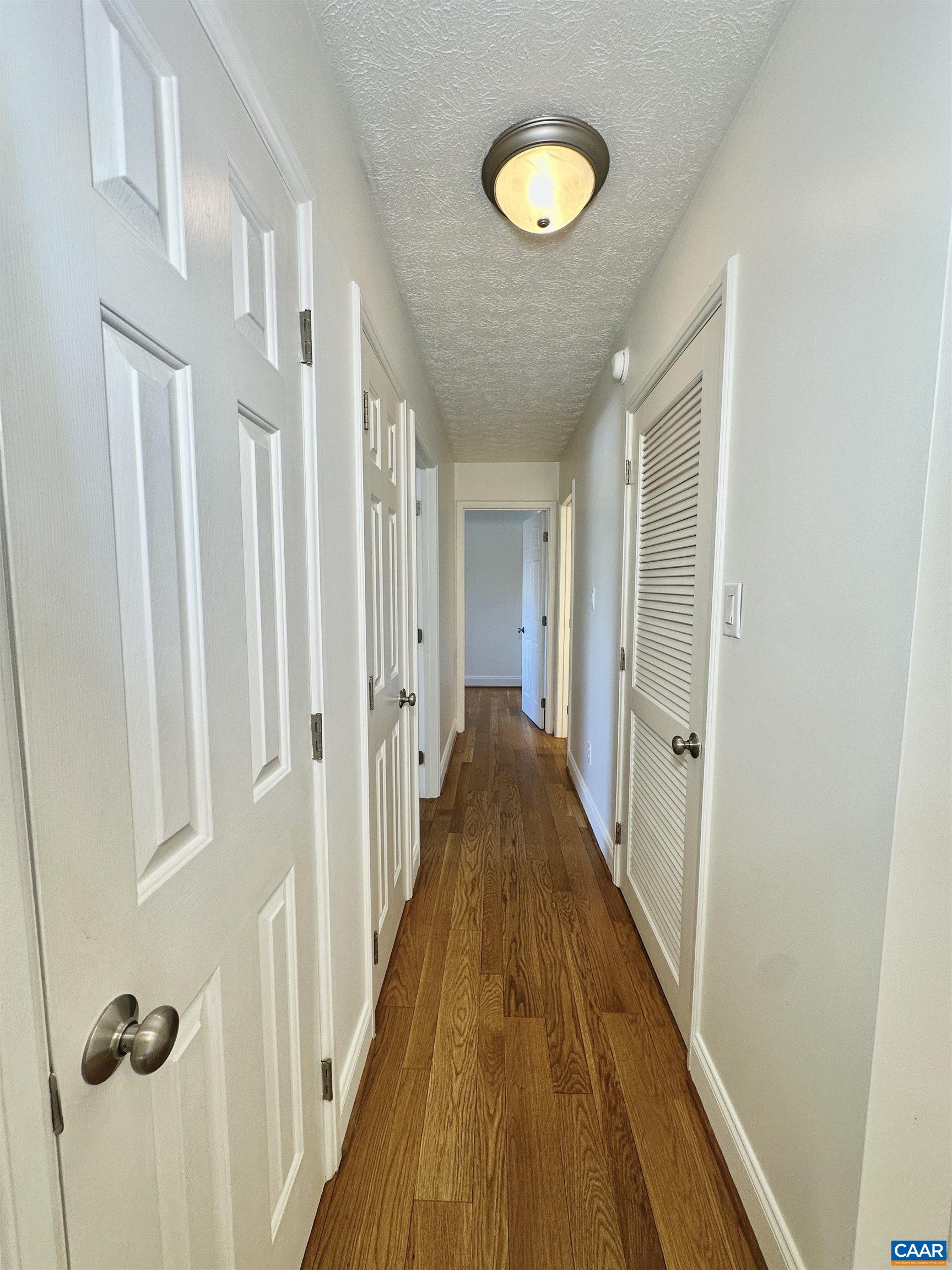 104 Turtle Creek Road, Unit 9 Charlottesville, VA 22901 - Photo 10 of 23 a view of a hallway with wooden floor