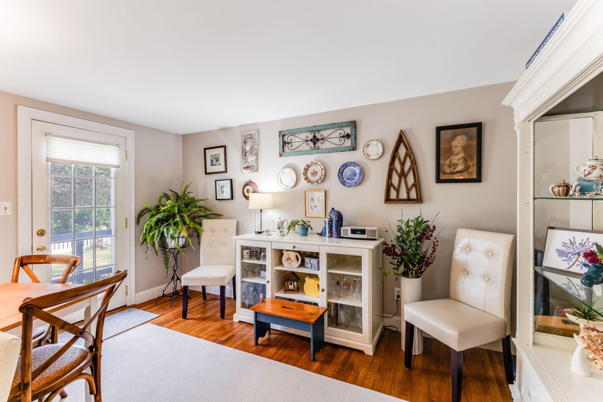 4975 State Highway, Unit A Eastham, MA 02642 - Photo 21 of 44 a living room with furniture and paintings on the wall next to a window