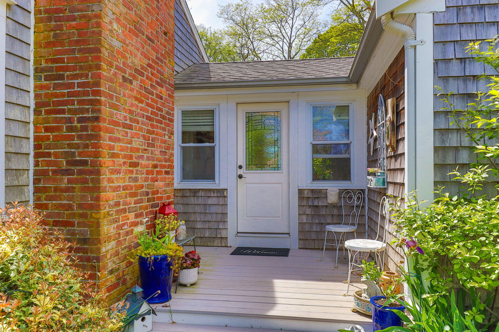 4975 State Highway, Unit A Eastham, MA 02642 - Photo 5 of 44 a front view of a house with a garden