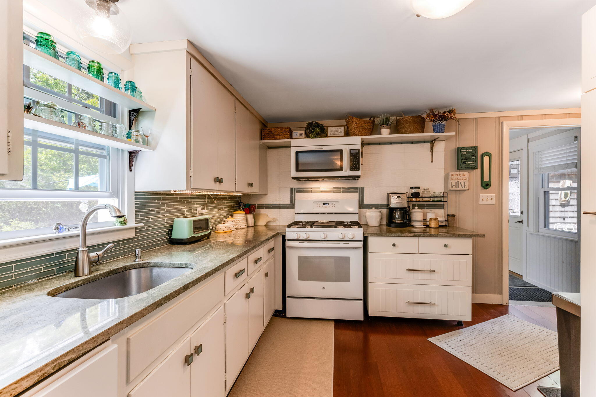 4975 State Highway, Unit A Eastham, MA 02642 - Photo 9 of 44 a kitchen with stainless steel appliances granite countertop a sink and cabinets