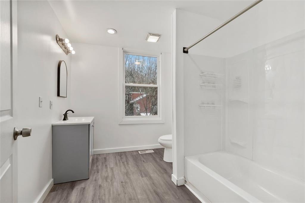 1619 Haug Street Pittsburgh, PA 15212 - Photo 14 of 27 a bathroom with a bathtub a toilet a sink and mirror