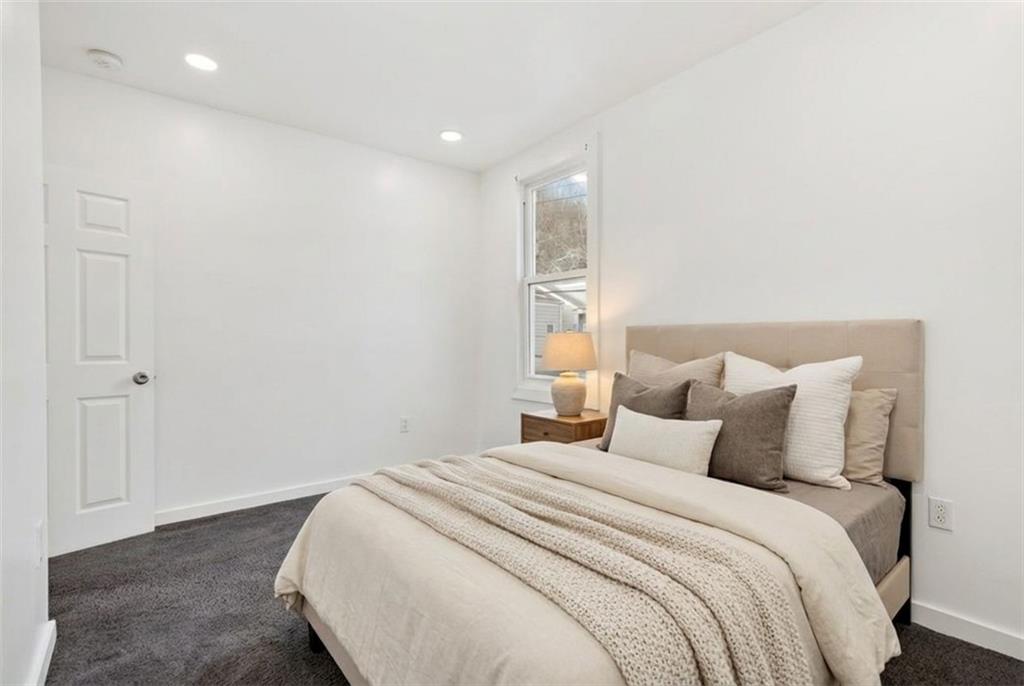 1619 Haug Street Pittsburgh, PA 15212 - Photo 17 of 27 a bedroom with a bed and a night stand