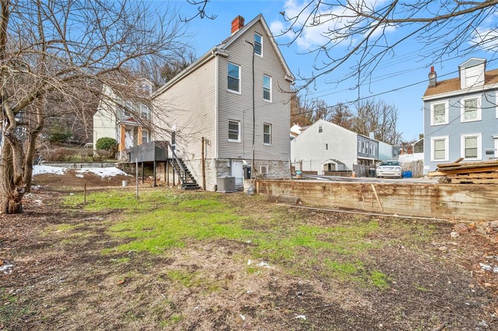 1619 Haug Street Pittsburgh, PA 15212 - Photo 26 of 27 a view of a white house next to a big yard with large trees
