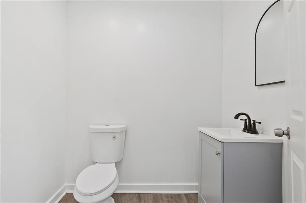 1619 Haug Street Pittsburgh, PA 15212 - Photo 10 of 27 a bathroom with a toilet a sink and mirror