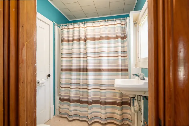 a bathroom with a shower curtain and a curtain