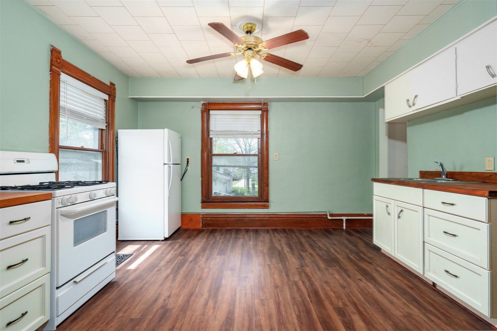 765 North Main Street Pontiac, IL 61764 - Photo 20 of 30 a kitchen with cabinets wooden floor and a fireplace