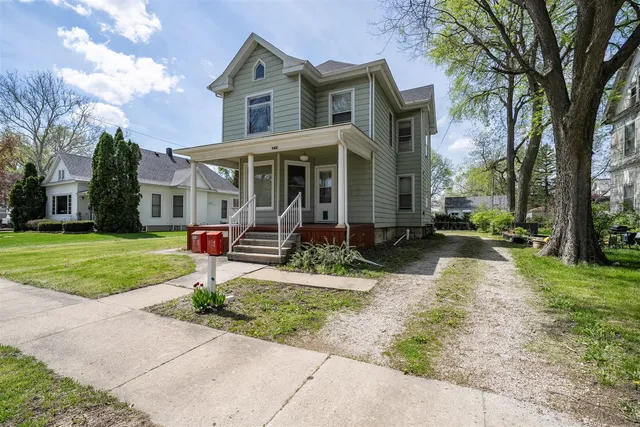 a front view of house with yard and green space