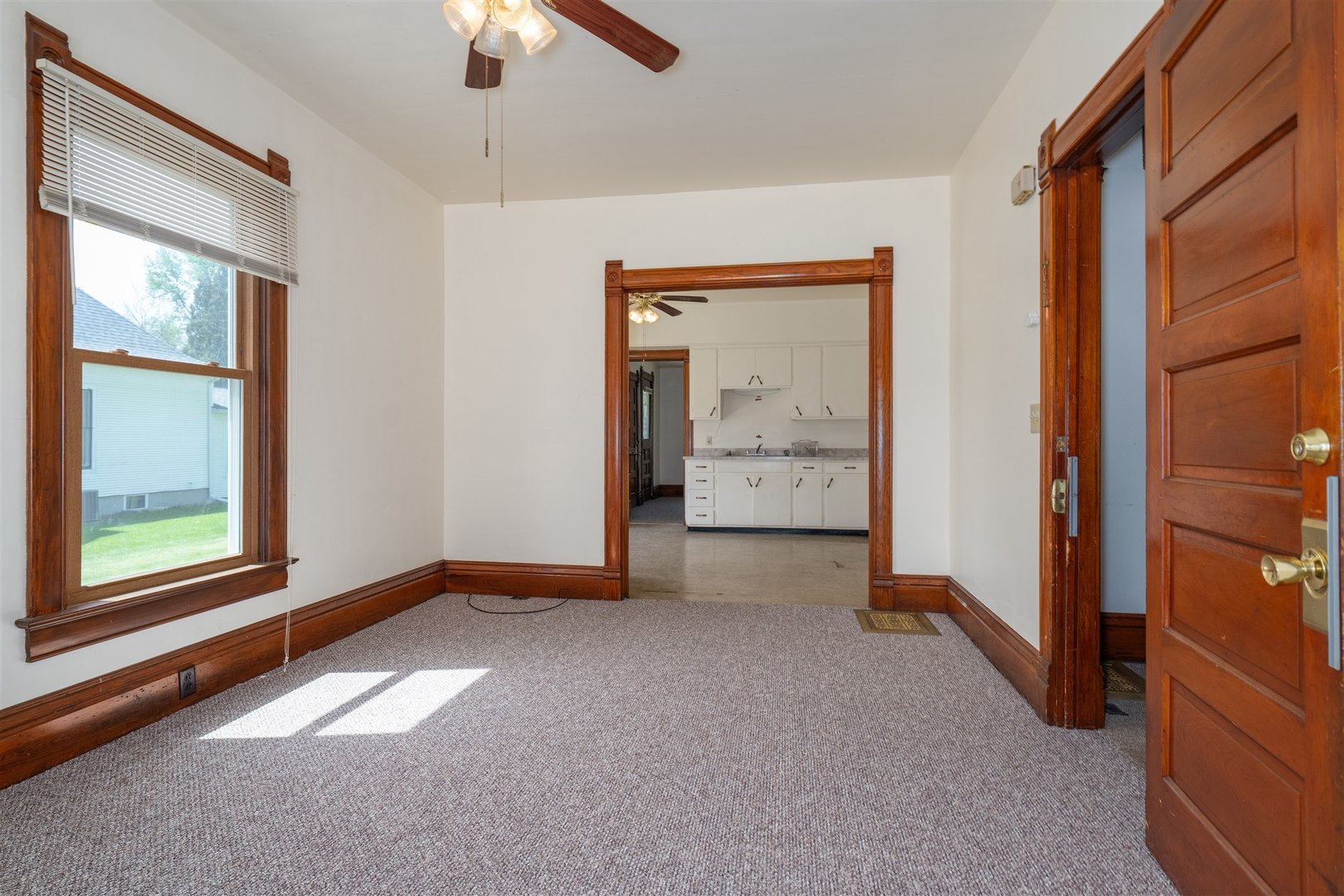 765 North Main Street Pontiac, IL 61764 - Photo 4 of 30 an empty room with chandelier fan and windows