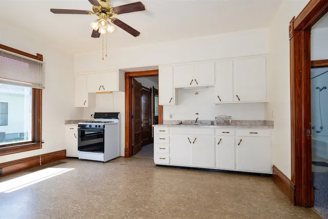 a kitchen with cabinets stainless steel appliances and a window