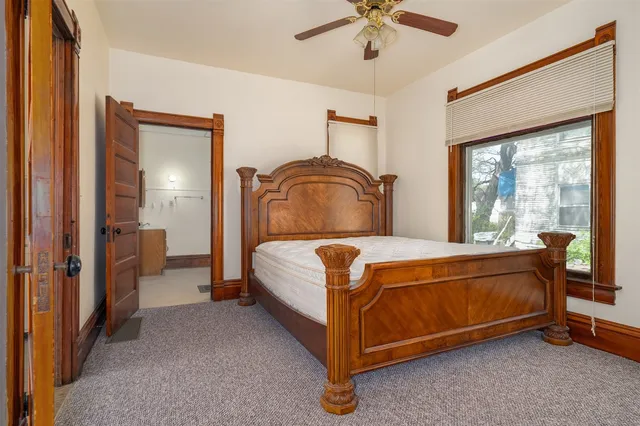 a bed sitting in a room next to a window