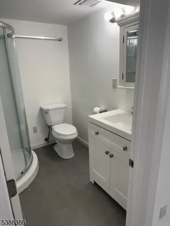 a white toilet sitting next to a bathroom sink