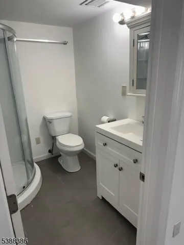 a white toilet sitting next to a bathroom sink