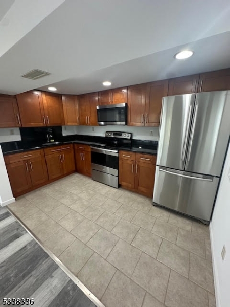 142 Mt Arlington Boulevard Landing, NJ 07850 - Photo 3 of 18 a kitchen with stainless steel appliances granite countertop a refrigerator a sink a stove a microwave and island