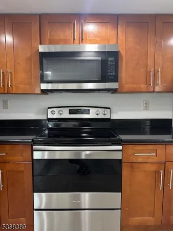 a stove top oven sitting inside of a kitchen