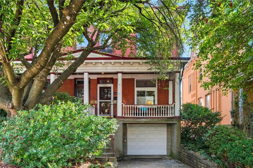 front view of a house with a tree