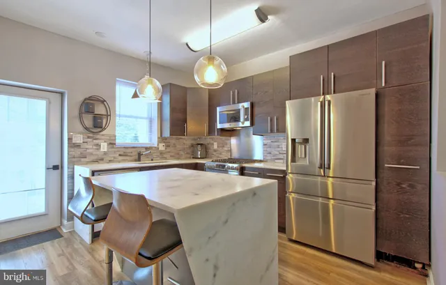 a kitchen with cabinets a refrigerator and a sink